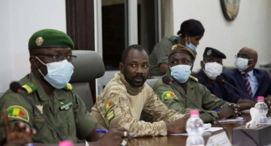 Colonel Assimi Goita, centre, has been granted presidential-like powers as head of the new junta, according to a document posted on Mali's official gazette.  By ANNIE RISEMBERG AFP