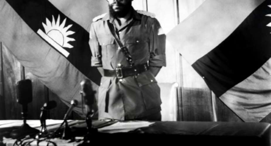 Colonel Chukwuemeka Odumegwu Emeka Ojukwu, the leader of the breakaway Republic of Biafra, stands in front of a Biafra flag.  By - AFPFile
