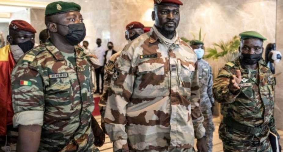Colonel Mamady Doumbouya, centre, led the coup against President Alpha Conde.  By JOHN WESSELS AFP
