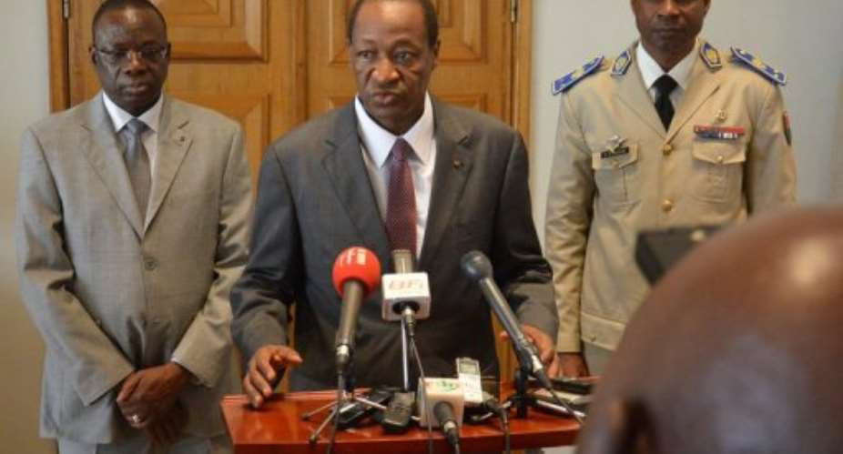 Blaise Compaore (centre) speaks at a press conference on May 14, 2013, at the presidential palace in Ouagadougou.  By Ahmed Ouoba (AFP/File)