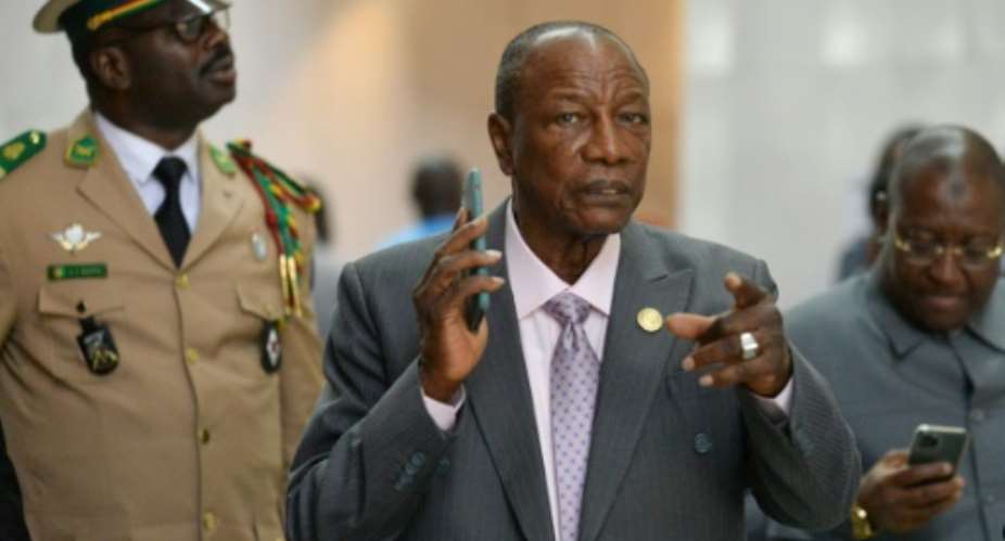 Conde, centre, has been ambiguous about whether he will seek a third term.  By Michael TEWELDE (AFP)