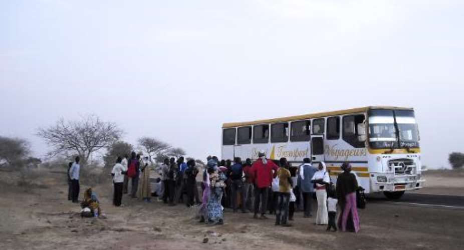 A bus carrying displaced people from the Diffa region, fleeing fighting between army and Boko Haram on the border between Niger and Nigeria, are checked by police on the outskirts of Zinder, Niger, on February 13, 2014.  By Robert Leslie AFPFile
