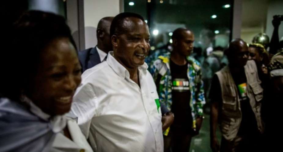 Newly re-elected Congo President Denis Sassou Nguesso 2nd L and his wife Antoinette L leave campaign headquarters in Brazzaville.  By Marco Longari AFP