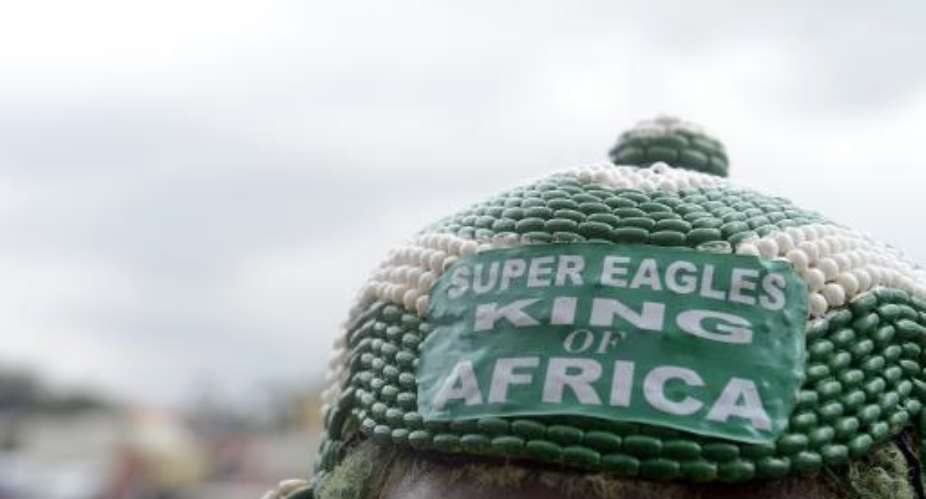 A Nigerian supporter wears a hat reading :Super Eagles king of Africa on June 16, 2014 in Lagos.  By Pius Utomi Ekpei AFPFile