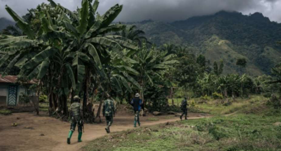 Congolese troops patrolling the village of Mwenda earlier this year. The village lies in an area that is notorious for attacks by the Allied Democratic Forces ADF.  By ALEXIS HUGUET AFP