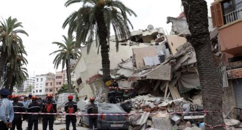 Moroccan rescuers inspect the rubble of a residential building that collapsed on July 11, 2014 in the city of Casablanca.  By  AFPFile