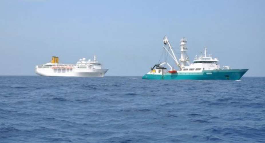 Handout photo released by the Reunion Island Prefecture shows the Costa Allegra (L) being towed by The Trevignon.  By  (AFP/Reunion Island)