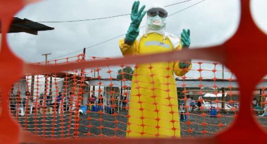 A health worker, wearing Personal Protective Equipment, stands inside the high-risk area at Elwa hospital in Monrovia on September 7, 2014.  By Dominique Faget AFPFile