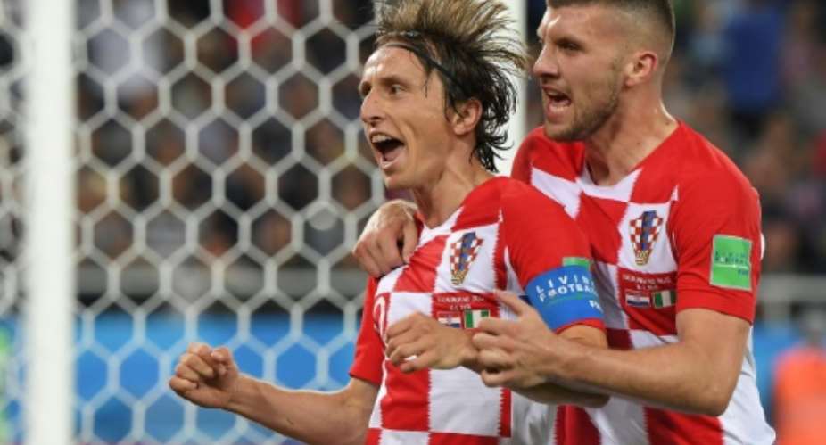 Croatias midfielder Luka Modric (L) celebrates scoring a penalty with his teammate forward Ante Rebic during the Russia 2018 World Cup Group D football match at the Kaliningrad Stadium in Kaliningrad on June 16, 2018.  By Patrick HERTZOG (AFP)
