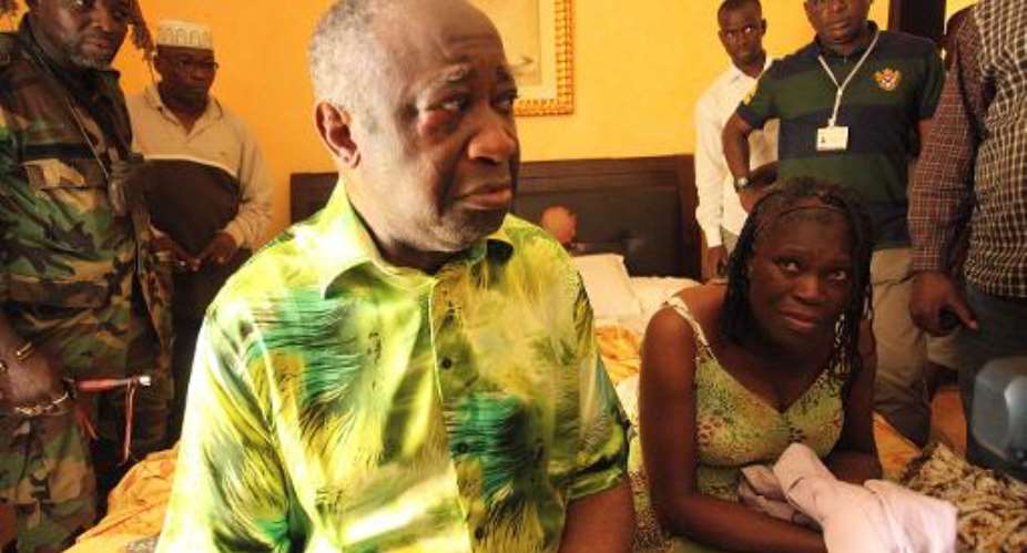 Ivory Coast strongman Laurent Gbagbo and his wife Simone sit on a bed at the Golf Hotel in Abidjan after their arrest on April 11, 2011.  By Aristide Bodegla AFPFile
