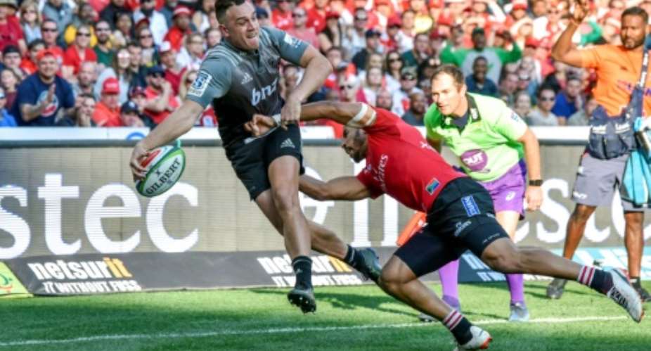 Crusaders Israel Dagg (L) is tackled by Lions Courtnall Skosan during the Super XV rugby final match at the Ellis Park Rugby stadium on August 5, 2017 in Johannesburg.  By CHRISTIAAN KOTZE (AFP)