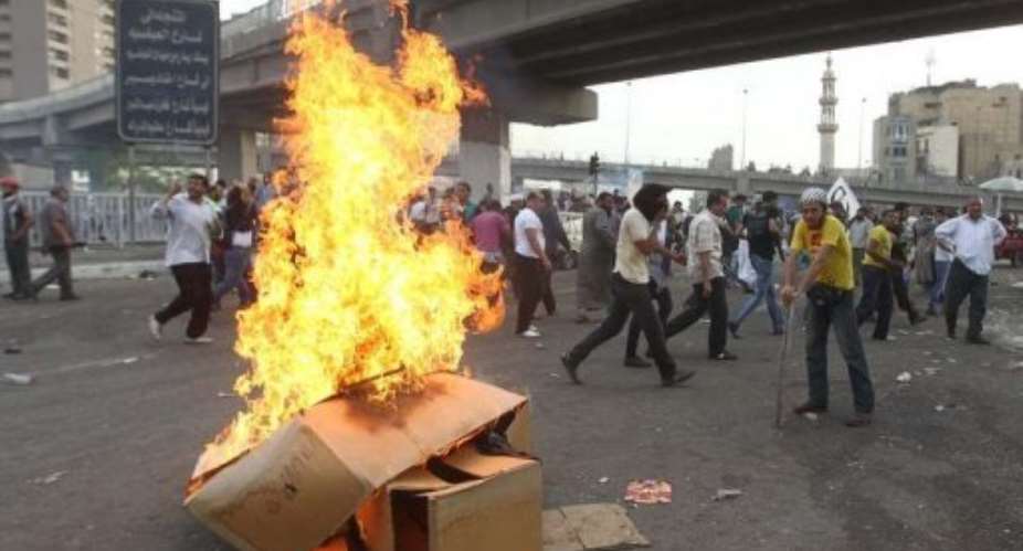Egyptian protesters set cardboard boxes on fire during an anti-military demonstration in Cairo.  By Khaled Desouki AFPFile