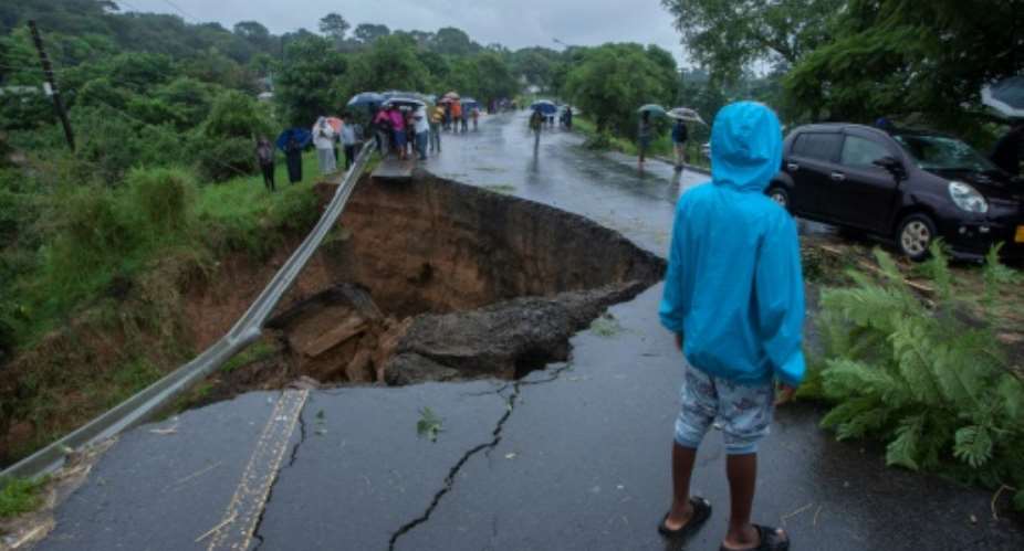 Cyclone Freddy's heavy rains caused floods which collapsed this road in Blantyre, Malawi.  By Amos Gumulira (AFP)