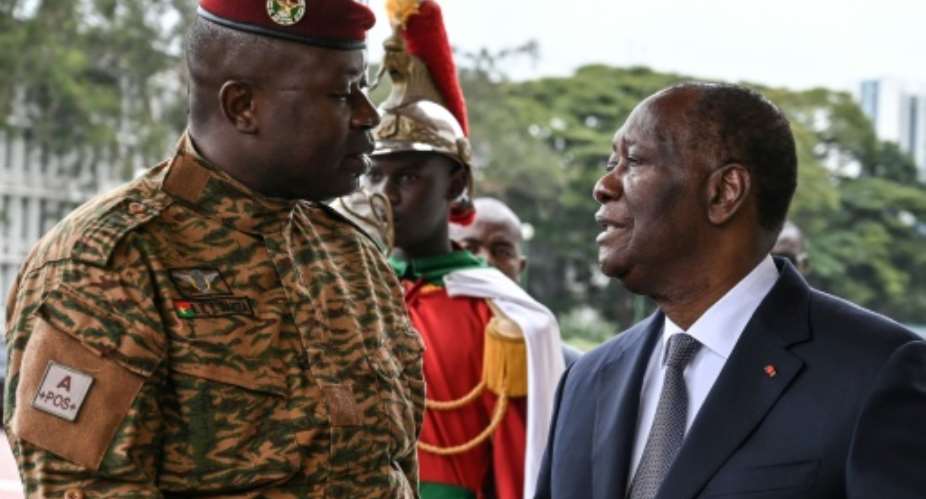 Damiba, left, met with President Alassane Ouattara during his one-day visit to Abidjan for 'friendship and work'.  By Sia KAMBOU AFP
