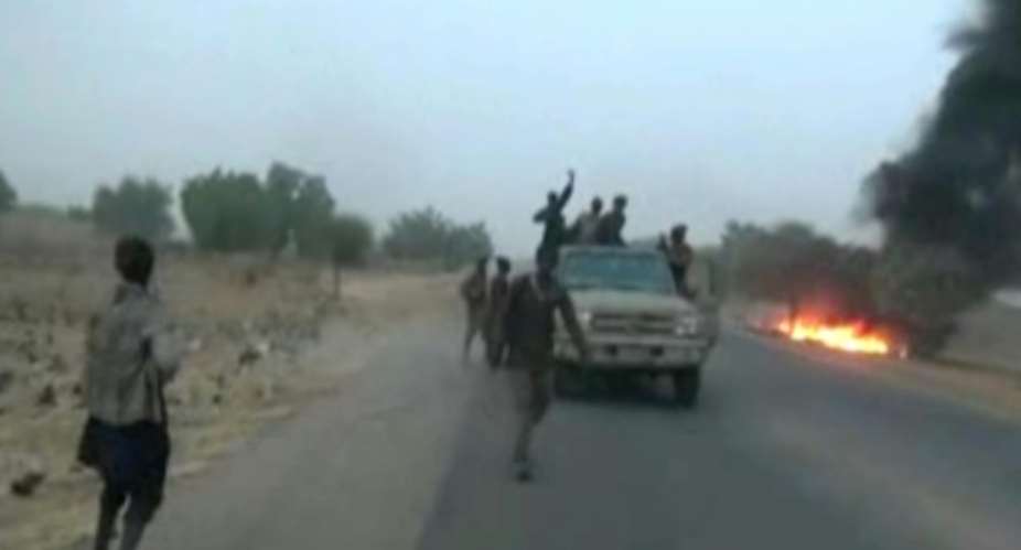 Dangerous roads: A screen grab from a January 2018 video released by Boko Haram, showing jihadists attacking the military on a highway near Maiduguri.  By Handout BOKO HARAMAFPFile