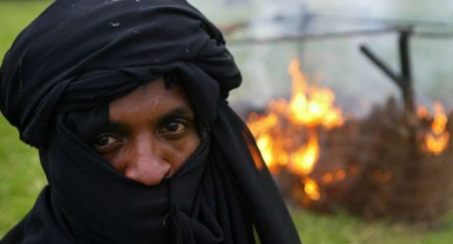 Darfur survivors re-enact the destruction of their homes by the Janjaweed militia, on July 5, 2005.  By John D Mchugh (AFP/File)