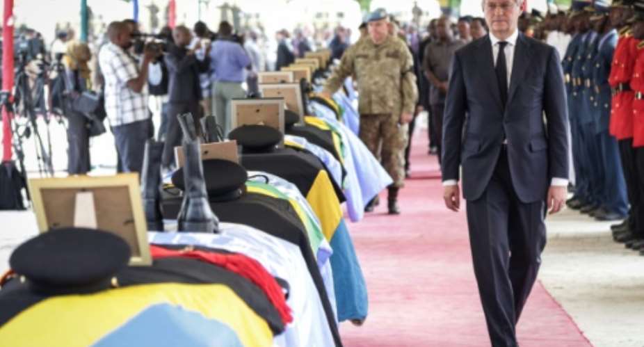 David Gressly, the UN's deputy special representative for the Democratic Republic of Congo, walks along the coffins of Tanzanian peacekeeperes killed in a December 7 attack in the Beni territory of North Kivu province, DR Congo.  By - AFPFile