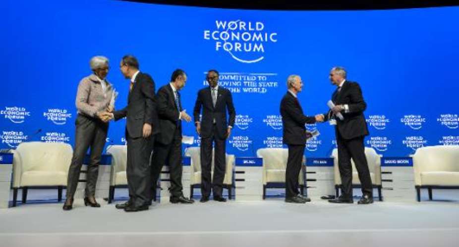 Rwandan President Paul Kagame C greets members of the business and political elite during their session at the World Economic Forum on January 23, 2015 in Davos, Switzerland.  By Fabrice Coffrini AFPFile