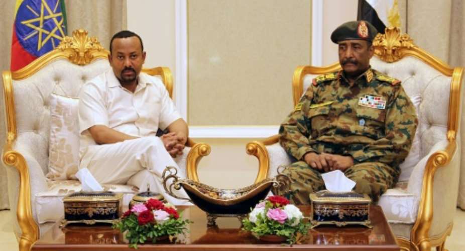 Days after a deadly crackdown on a protest camp in Khartoum, Ethiopia's Prime Minister Abiy Ahmed L, pictured June 7, 2019 met with Sudan's ruling military council General Abdel Fattah al-Burhan R to try to mediate between the two sides.  By - AFPFile