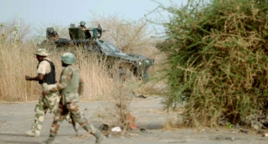 Nigerian soldiers patrol in the north of Borno state on June 5, 2013 near Maiduguri.  By Quentin Leboucher AFPFile