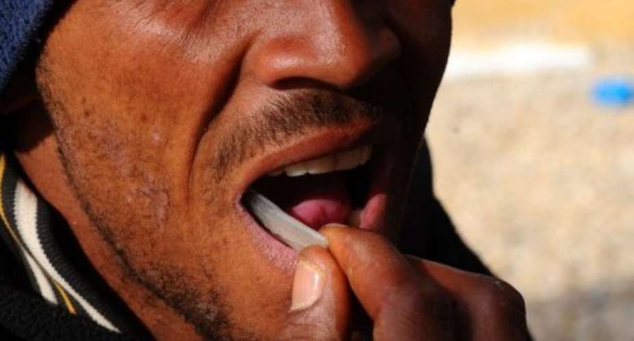 A man slips a plastic pouch of gems into his mouth, hiding his illicit haul.  By Alexander Joe (AFP/File)