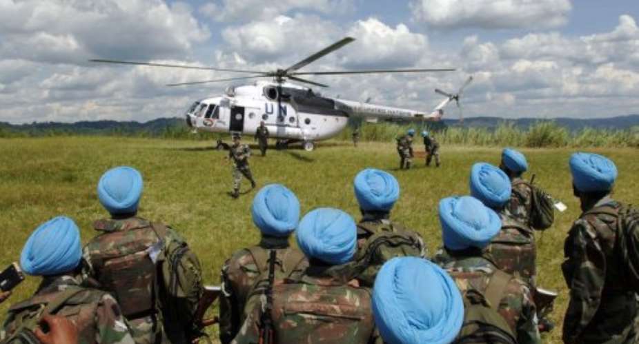 United Nations peacekeepers from India wait to board an helicopter in Muhanga.  By Lionel Healing AFPFile