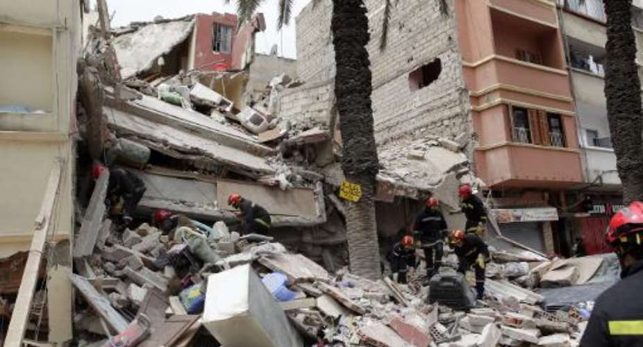 Moroccan rescuers inspect the rubble of a residential building that collapsed in Casablanca on July 11, 2014.  By - AFPFile