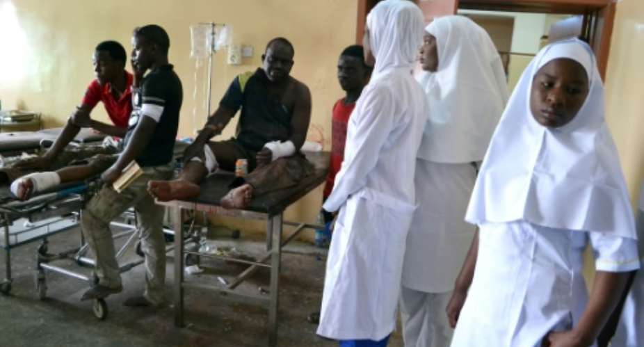 Nurses stand next to victims of the multiple blasts blamed on Boko Haram, at the State Specialist Hospital in Maiduguri on September 21, 2015.  By  AFPFile