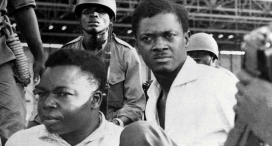 December 1960: Soldiers guard Congo's first post-independence prime minister, Patrice Lumumba, right, after his arrest. To the left is Joseph Okito, vice president of the Senate, who was shot dead alongside Lumumba the following month.  By STRINGER AFPFile
