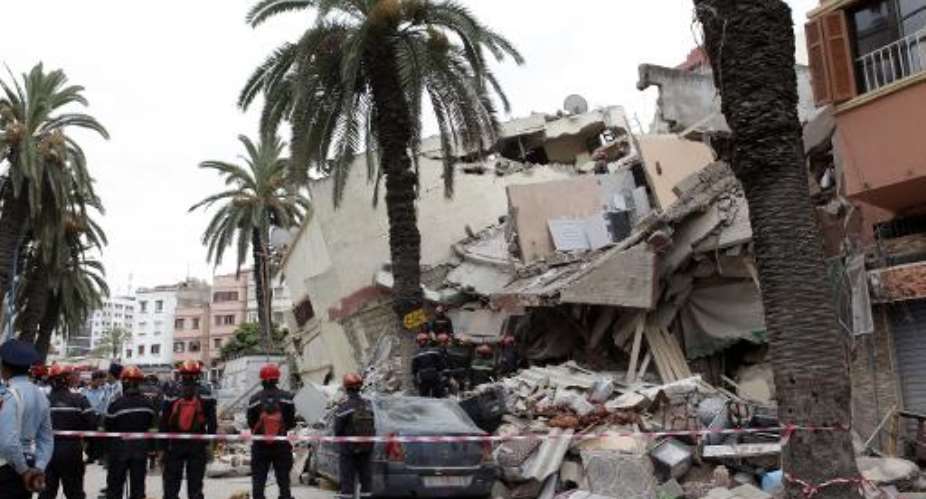 Moroccan rescuers inspect the rubble of a residential building that collapsed on July 11, 2014 in the Moroccan city of Casablanca.  By  (AFP/File)