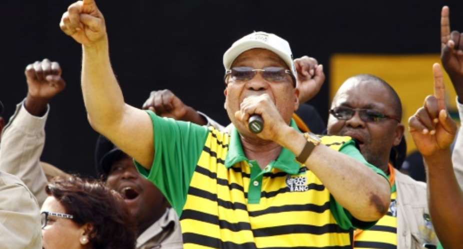 South African president and African National Congress ANC's president Jacob Zuma sings and dances during the Party official launch of the Municipal Elections manifesto on April 16, 2016 in Port Elizabeth, South Africa.  By Michael Sheehan AFPFile