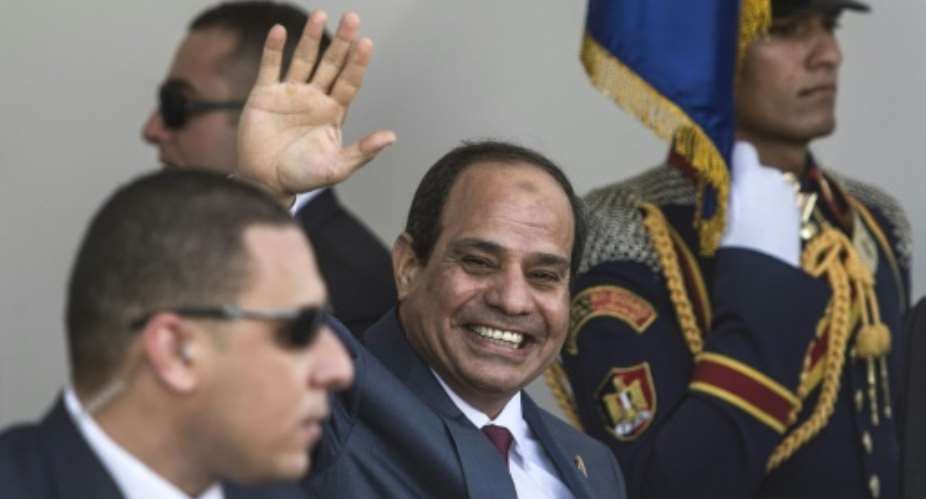 Egyptian President Abdel Fattah al-Sisi waves as he arrives for the opening ceremony of a new waterway at the Suez Canal on August 6, 2015, in the port city of Ismailiya.  By Khaled Desouki AFPFile