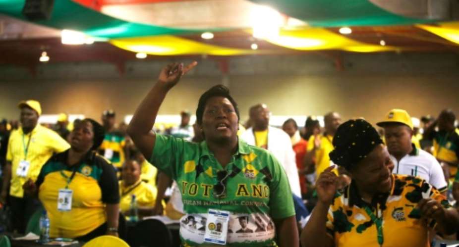 Delegates sing during the plenary session of the African National Congress.  By WIKUS DE WET AFP
