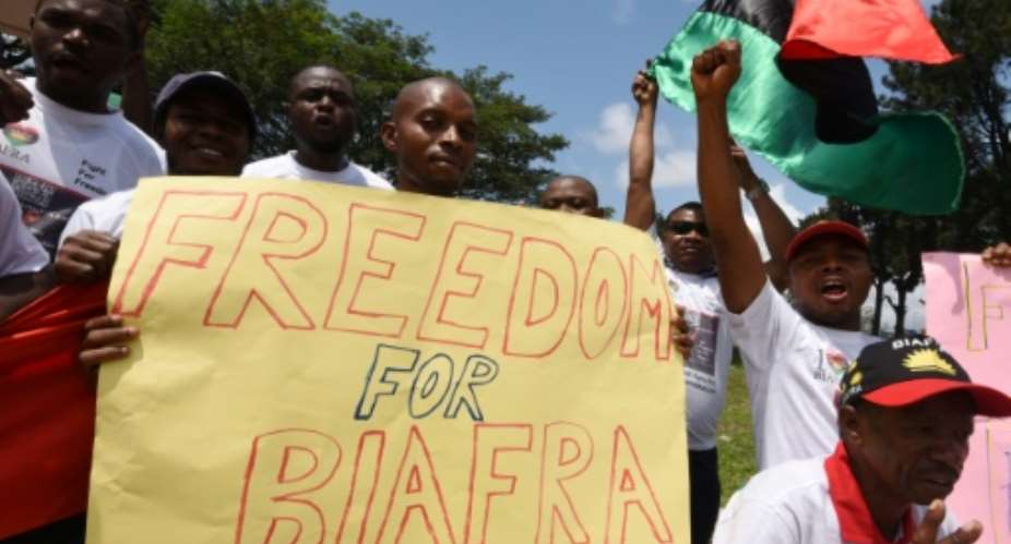 Demonstrators from the Indigenous People of Biafra IPOB group wave flags and hold a sign reading Freedom for Biafra during a protest  in Abidjan on September 23, 2016 calling for the release of pro-Biafra leader Nnamdi Kanu.  By Sia Kambou AFPFile