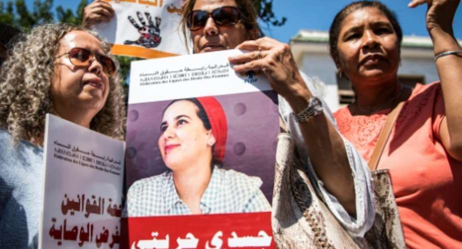 Demonstrators protested outside a Moroccan court as the trial opened of journalist Hajar Raissouni, accused of having a late-term abortion and sexual relations outside of marriage.  By FADEL SENNA AFP