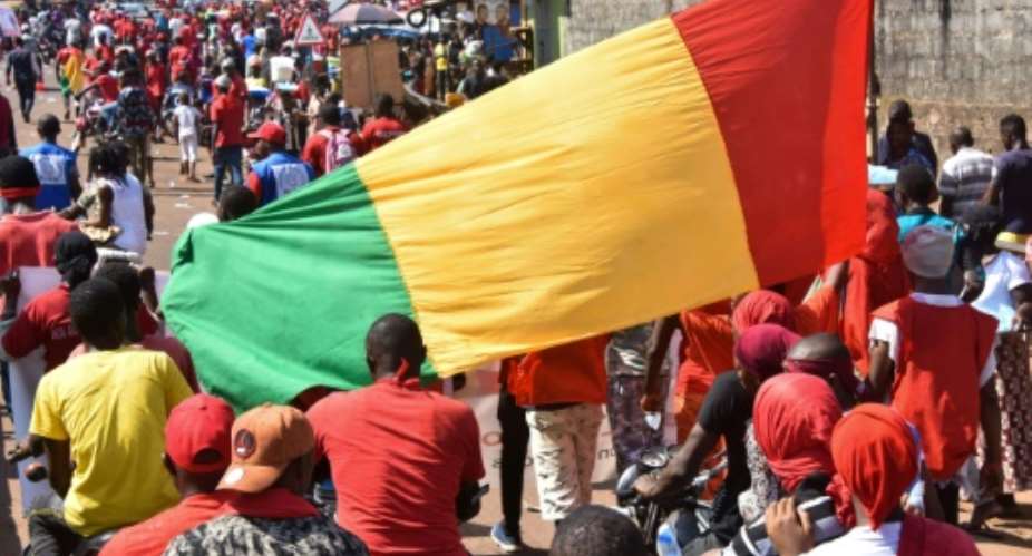 Demonstrators take part in a protest against the third term of Guinean President Alpha Conde, in Conakry, on November 26.  By CELLOU BINANI AFPFile