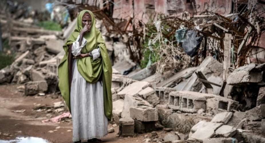 Devastation: A woman looks at the remains of the school in flood-hit Beledweyne.  By LUIS TATO AFP