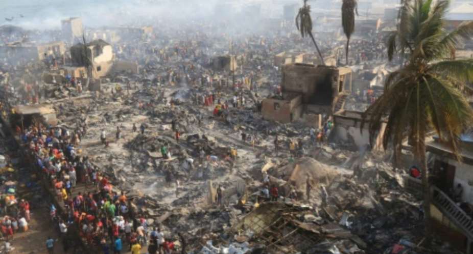Devastation: Stunned inhabitants of Susan's Bay looked at the aftermath of the fire.  By Saidu BAH AFP