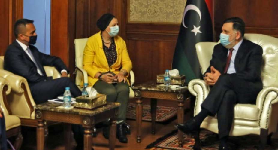 Di Maio L met Sarraj R during his first visit to war-torn Libya since January.  By - AFP