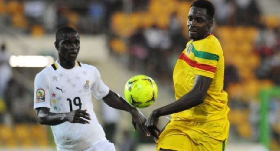 Mali's striker Cheick Diabate R fights for the ball with Ghana's Jonathan Mensah.  By Alexander Joe AFP