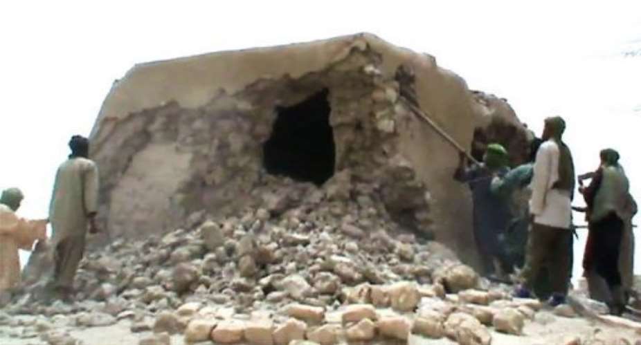 A still from a video shows Islamist militants destroying an ancient shrine.  By  AFP