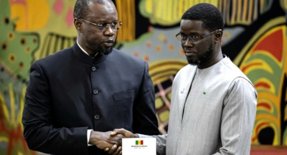 Discord has grown between Senegals now-dismissed Prime Minister Ousmane Sonko (L) and President Bassirou Diomaye Faye (R) pictured during an 2025 event in Dakar.  By PATRICK MEINHARDT (AFP/File)