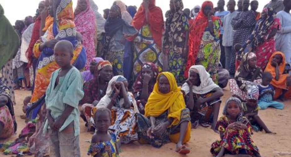 Women and children fleeing from Boko Haram attacks sit at Kabalewa Refugee Camp, Diffa in Niger Republic, on March 13, 2015.  By Olatunji Omirin AFPFile