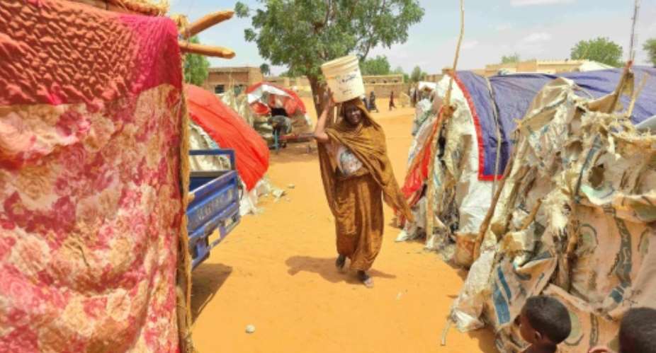 Displaced residents of southern Kordofan must walk long distances to find water during fighting between the government army and the paramilitary Rapid Support Forces.  By - (AFP)