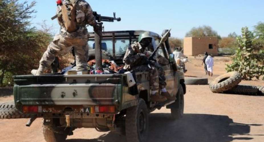 Malian soldiers on a pickup truck drive toward a Malian Army checkpoint in Gao on February 8, 201.  By Pascal Guyot AFPFile