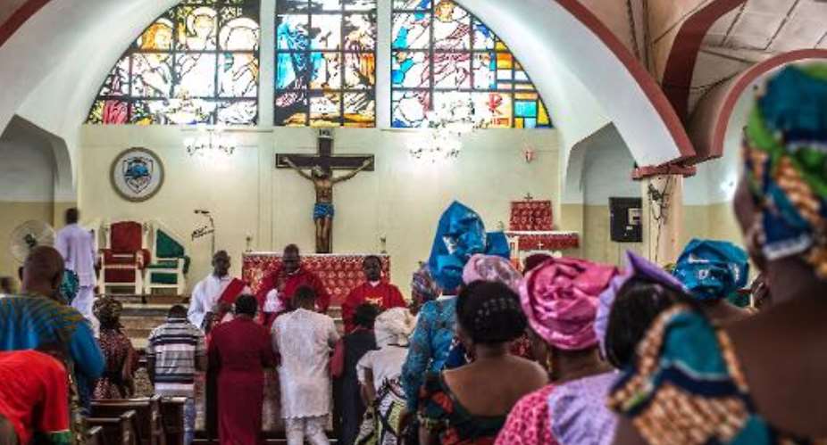 Nigerians attend Sunday mass at Saint Joseph's Cathedral, a rare church in the predominately Muslim area of Kaduna, where peace was preached on March 29, 2015.  By Nichole Sobecki AFP