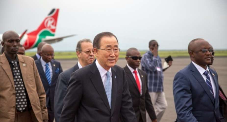 United Nations Secretary-General Ban Ki-Moon C walks with Burundi's Vice President Gaston Sindimwo at Bujumbura airport on February 22, 2016.  By Griff Tapper AFP