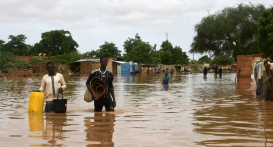 Dozens of residents in the capital Niamey fled their homes earlier on Thursday, wading or swimming through flooded streets.  By BOUREIMA HAMA AFP