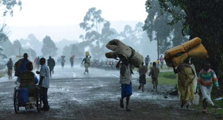 Congolese refugees returning from Uganda walk back home on November 1, 2013, in Bunagana, 99 kms from the eastern Democratic Republic of Congo city of Goma, at the frontier with Uganda.  By Junior D. Kannah AFPFile