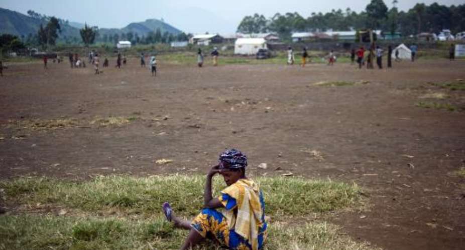 A displaced Congolese woman sits on July 14, 2014 in the Bulengo camp for internally displaced persons, 20 kms west of Goma in eastern DR Congo.  By Phil Moore AFPFile